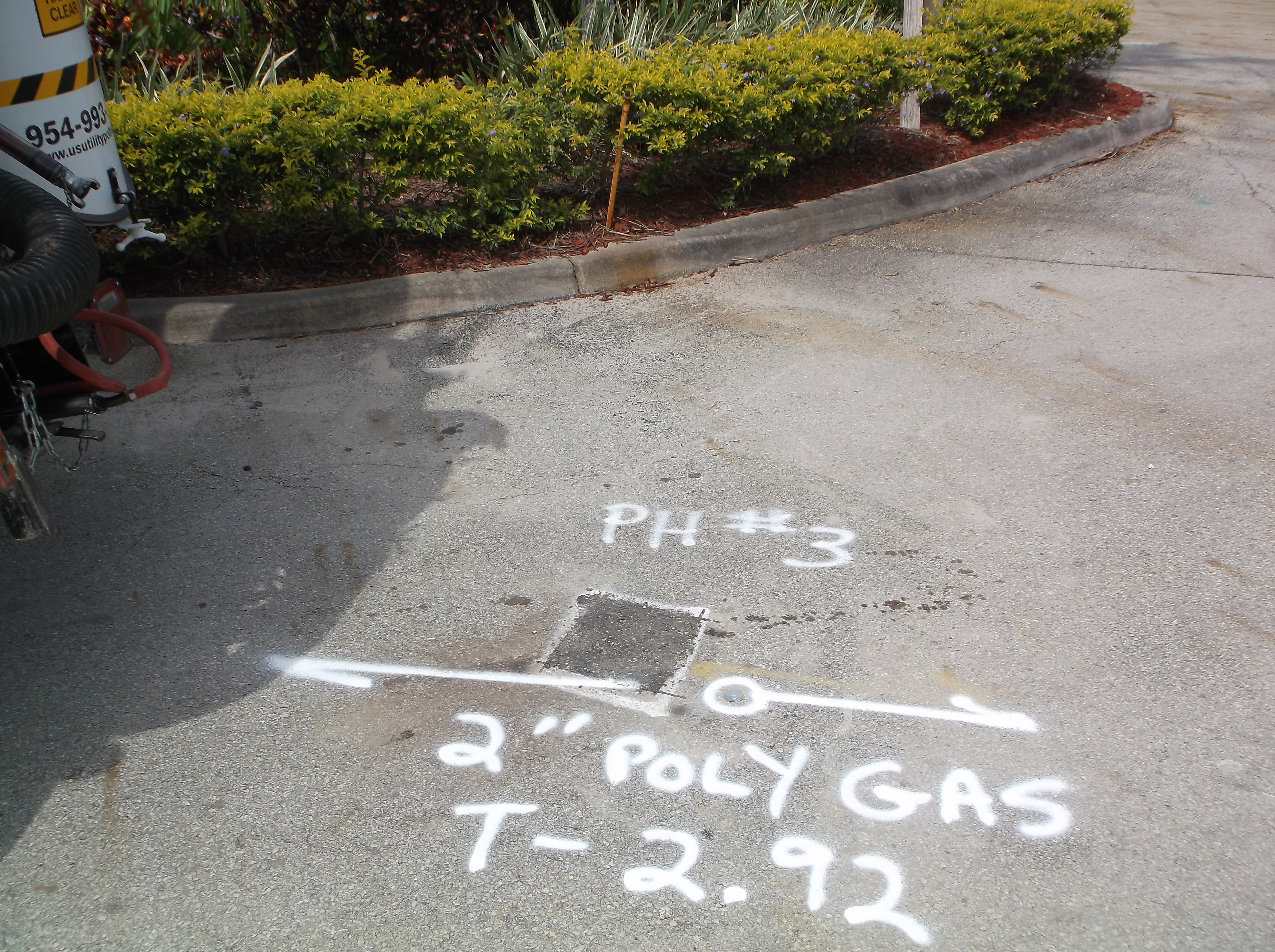 Paint marks on pavement reading PH#3 2-inch Poly Gas T-2.92 — utility locating field marking in South Florida